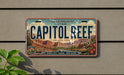 A vintage license plate from Utah, featuring the name "CAPITOL REEF" and the location "UTAH NATIONAL PARK".