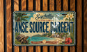 A vintage license plate from Seychelles, La Digue Island, with a tropical island landscape and palm trees.