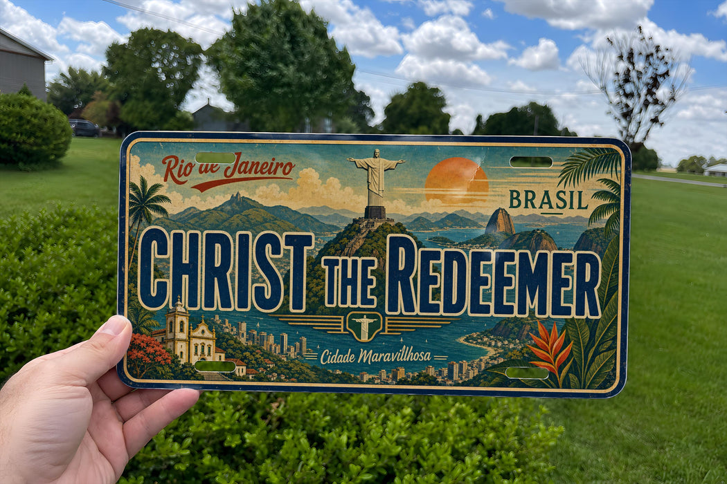 A person is holding a license plate with a colorful design featuring the Christ the Redeemer statue and the city of Rio de Janeiro, Brazil.