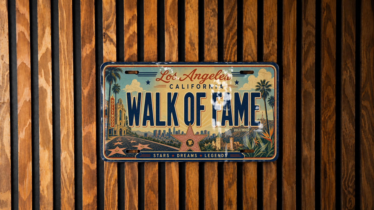 A vintage California license plate with the text "Los Angeles Walk of Fame" is displayed on a wooden wall.