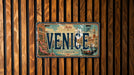 A vintage license plate from Venice, Italy, with a design depicting the city's landmarks and architecture.