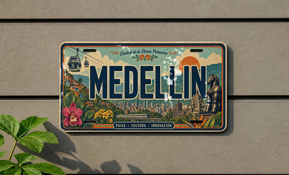 A vintage license plate from Medellín, Colombia, featuring a colorful illustration of the cityscape and landmarks.