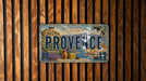 A vintage license plate from Provence, France, with a scenic illustration of the region.