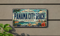A vintage license plate from Panama City Beach, Florida, featuring a beach scene and palm trees.
