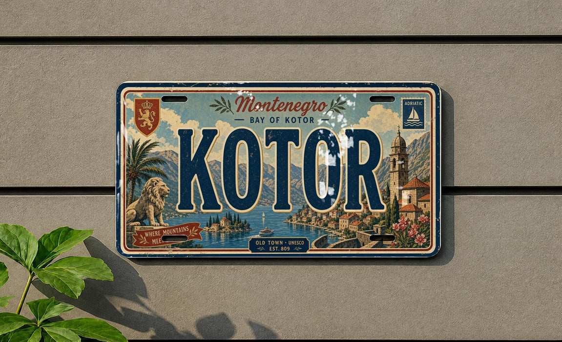 A vintage license plate from the town of Kotor, located in the Bay of Kotor, is displayed on a wall.