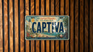 A vintage license plate from Florida, with the word "CAPTIVA" prominently displayed, is mounted on a wooden wall.