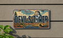 A license plate with the text "Devil's Tower" and a scenic illustration of the famous national monument in Wyoming.