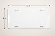 A white license plate with measurements and a scale.