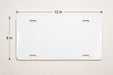 A white license plate with measurements and a scale.