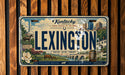 A vintage-style license plate from Kentucky featuring an illustration of the city of Lexington, with various landmarks and elements representing the state's history and culture.