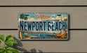 A California license plate with the text "NEWPORT BEACH" and a scenic illustration of the beach and ocean.