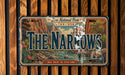 A vintage license plate with a scenic mountain landscape and the text "The Narrows" prominently displayed.