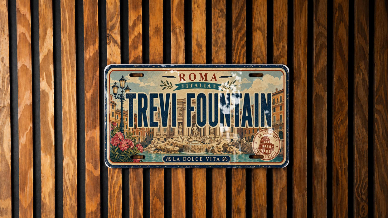 A vintage license plate from Italy that reads "TREVI FOUNTAIN" is displayed against a wooden background.