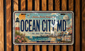 A vintage license plate with a beach scene and lighthouse, advertising Ocean City, MD as America's favorite family destination.