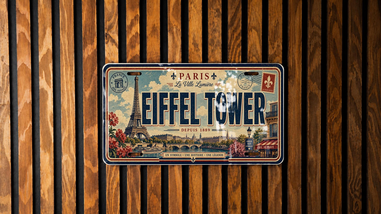 A vintage license plate from Paris, with the Eiffel Tower and other Parisian landmarks visible, is displayed on a wooden wall.