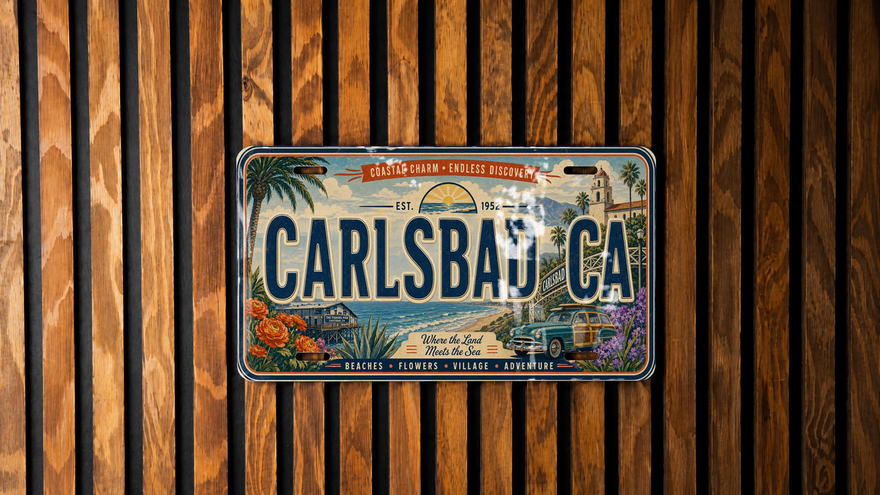 A vintage license plate from California, featuring a beach scene and a car, is displayed on a wooden wall.