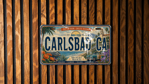 A vintage license plate from California, featuring a beach scene and a car, is displayed on a wooden wall.