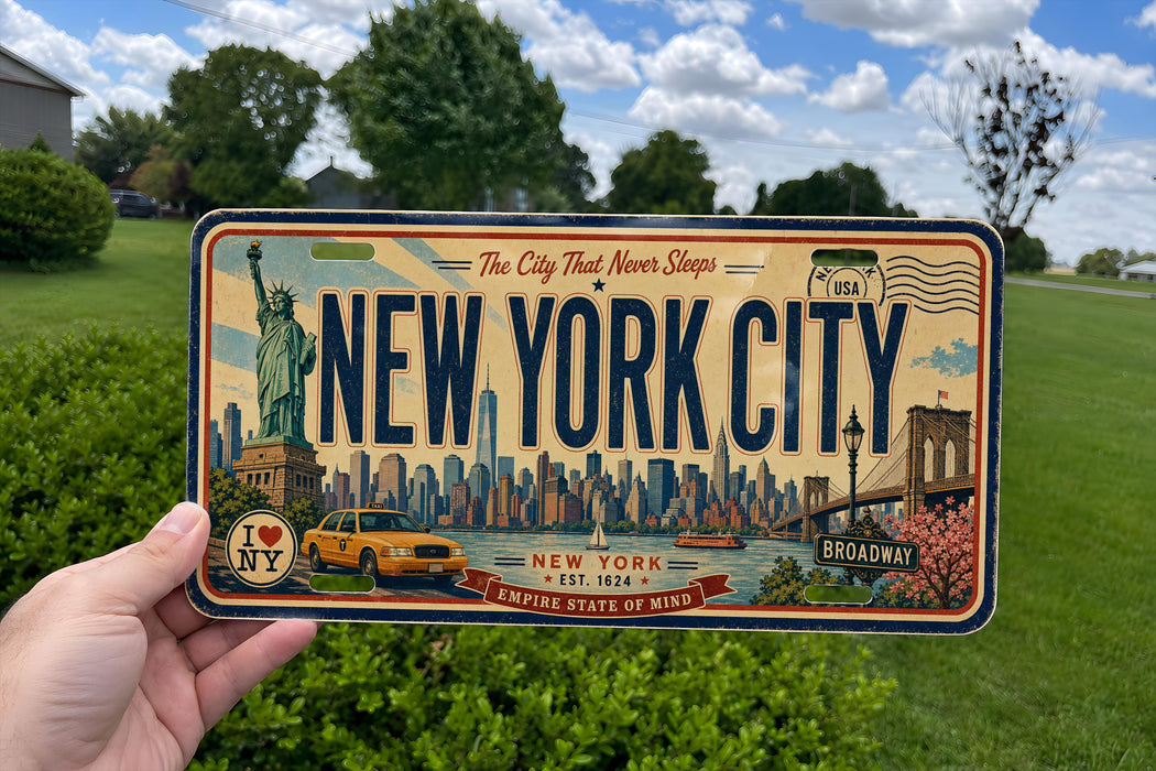 A vintage New York City license plate being held up against a backdrop of trees and a blue sky.