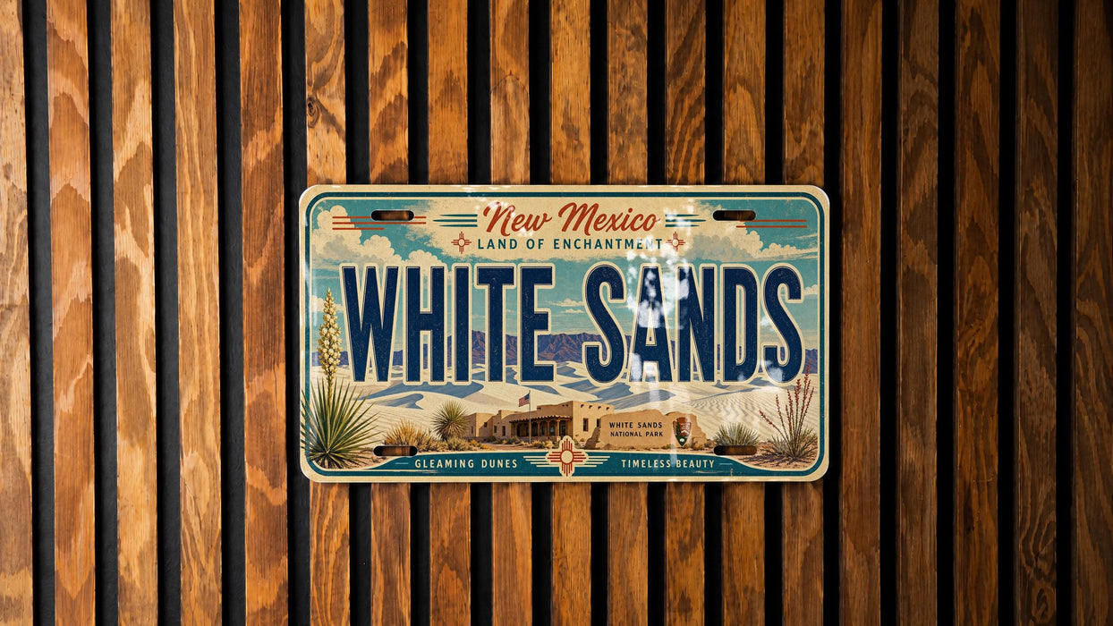 A vintage license plate from New Mexico, with the text "New Mexico" and "Land of Enchantment" printed on it, along with the word "WHITE SAND" prominently displayed.
