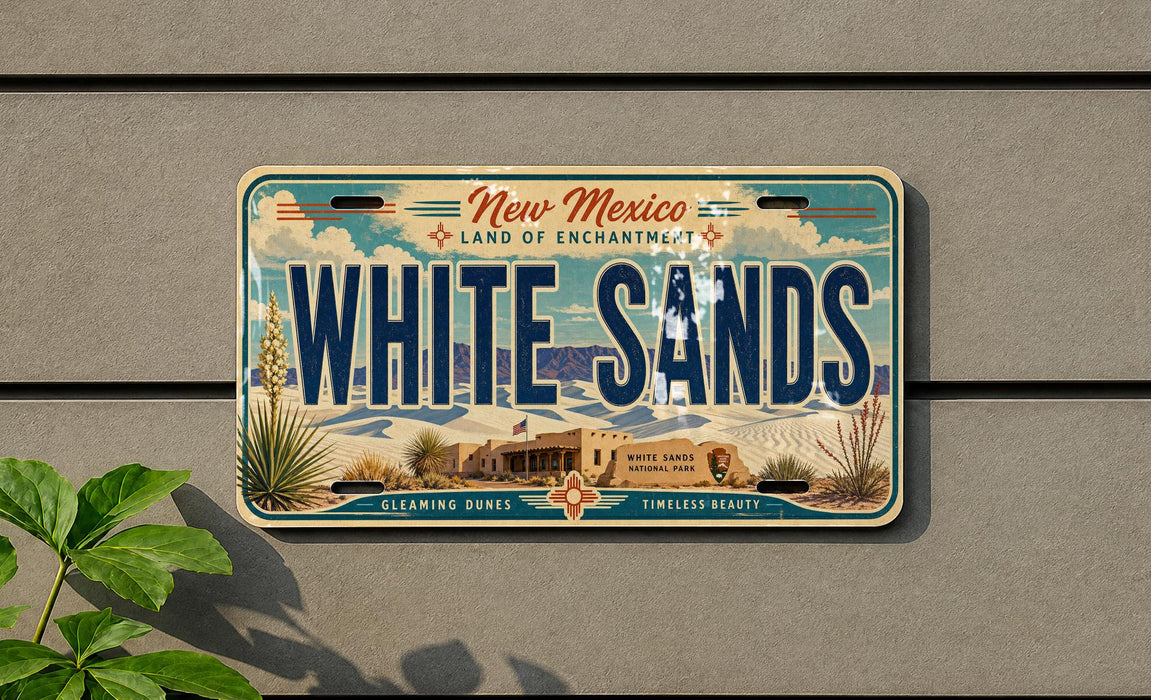 A license plate with the text "New Mexico Land of Enchantment" and "WHITE SAND" printed on it, along with a graphic of a desert landscape.