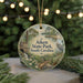 A decorative ornament featuring a scenic landscape with a bird, trees, and a waterfall, hanging from a string.