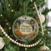 A round ornament hanging on a Christmas tree, featuring a scenic image of the Allegheny State Park in New York.