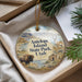 A decorative ornament with a scenic image of Antelope Island, Utah, featuring a bison, a deer, and a cabin, hanging from a string.