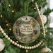 A round ornament on a Christmas tree, featuring a scenic image of Audra State Park in West Virginia.