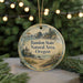 A round ornament with a scenic landscape of Bandon State Natural Area, Oregon, featuring a lighthouse, mountains, and a beach.