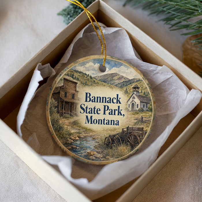 A decorative ornament in a box, featuring a scenic image of Bannack State Park, Montana.