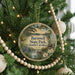 A round ornament hanging on a Christmas tree, featuring a scenic image of Barnwell State Park in South Carolina.