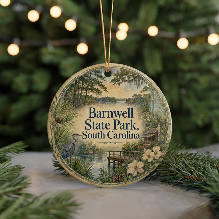 A circular ornament with a scenic image of Barnwell State Park in South Carolina, featuring a bird, a dock, and a lake, surrounded by pine trees and lights.