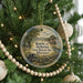 A round ornament on a Christmas tree, featuring a scene of a battle in the Battle of Athens, Missouri.