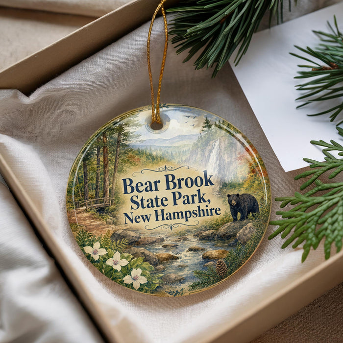 A round ornament with a scenic image of Bear Brook State Park in New Hampshire, featuring a bear, trees, and a stream.