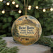 A round ornament with a landscape scene featuring a mountain, pine trees, and bison in the foreground, with the text "Bear Butte State Park, South Dakota" displayed on it.