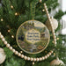 A circular ornament hanging on a Christmas tree, featuring a scenic image of Beartown State Park in West Virginia.