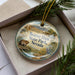A decorative ornament in a box, featuring a beaver and the text "Beaver Dam State Park, Nevada".