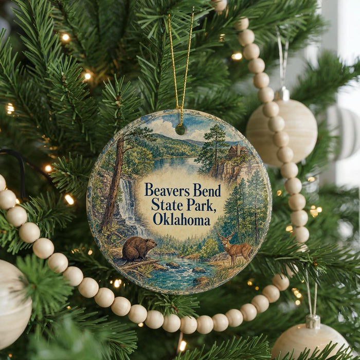 A round ornament hanging on a Christmas tree, featuring a scenic image of Beaver Bend State Park, Oklahoma.
