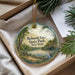 A round ornament with a scenic image of Belmont Lake State Park, New York, hanging from a string.
