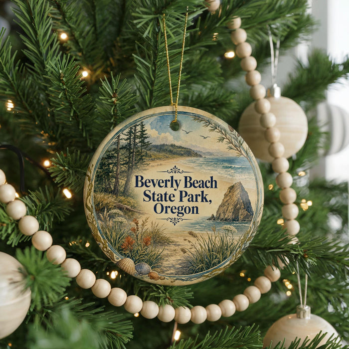 A round ornament hanging on a Christmas tree, featuring a scenic landscape with a beach, mountains, and a body of water.