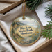 A decorative ornament with a scenic landscape of Big Arm State Park, Montana, featuring a cabin and mountains in the background.