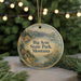 A round ornament with a scenic landscape of Big Arm State Park, Montana, featuring a cabin, mountains, and a lake.