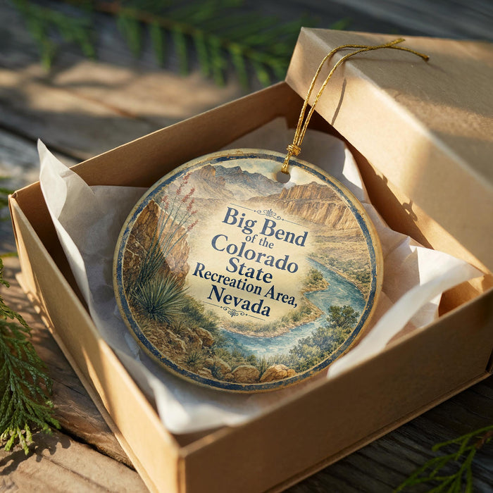 A decorative ornament in a wooden box, featuring a scenic landscape of mountains and a river.