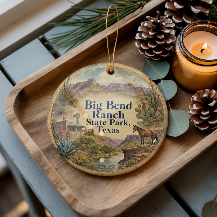 A wooden tray with a decorative ornament featuring a scenic image of Big Bend Ranch State Park, Texas, along with a candle and pine cones.
