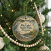 A round ornament hanging on a Christmas tree, featuring a scenic image of Big Lake State Park in Missouri.