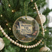 A Christmas tree decorated with ornaments, including a circular ornament with a scenic image of Blackwater Falls State Park, West Virginia.