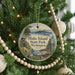 A round ornament hanging on a Christmas tree, featuring a scenic image of Blake Island State Park in Washington.