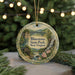 A decorative ornament featuring a scenic landscape with a bridge, waterfall, and pine trees, with the text "Bluestone State Park, West Virginia" prominently displayed.