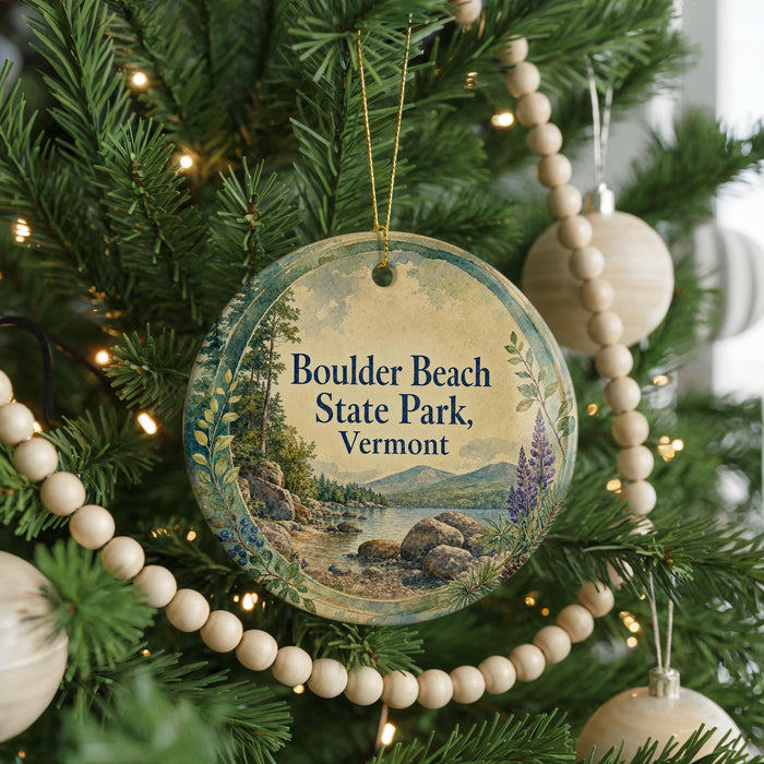 A round ornament hanging on a Christmas tree, featuring a scenic landscape of Boulder Beach State Park, Vermont.