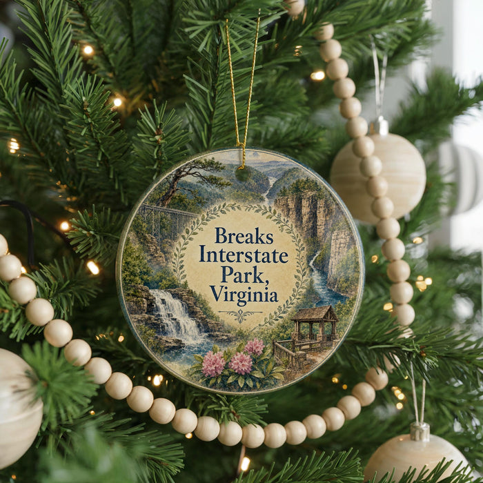 A round ornament hanging on a Christmas tree, featuring a scenic image of Breaks Interstate Park, Virginia.